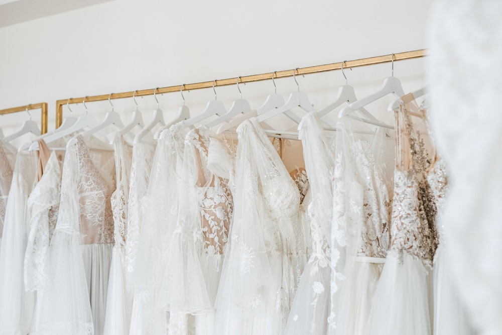 A variety of mermaid wedding dress hanging on a rack