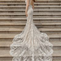 woman on stairs in an off-white mermaid wedding dress